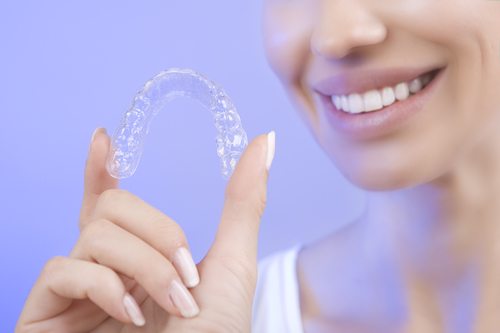 Smiling Girl with Clear Teeth Aligner