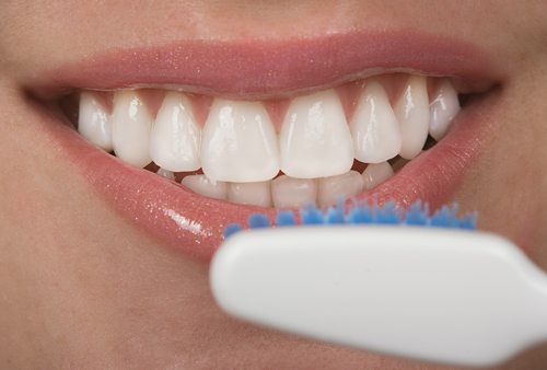 woman about to brush beautiful teeth