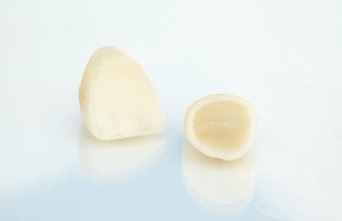 Two CEREC crowns with a light blue background.