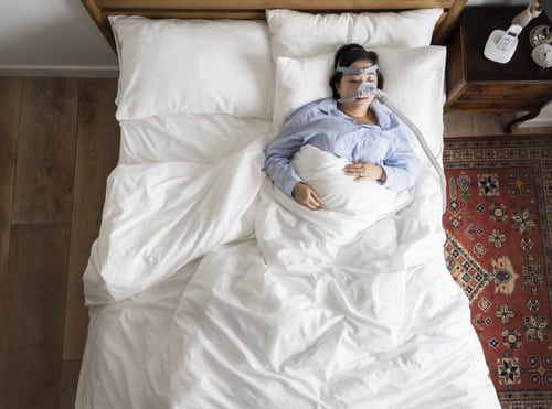 Overhead photo of a woman sleeping with an OSA mask.